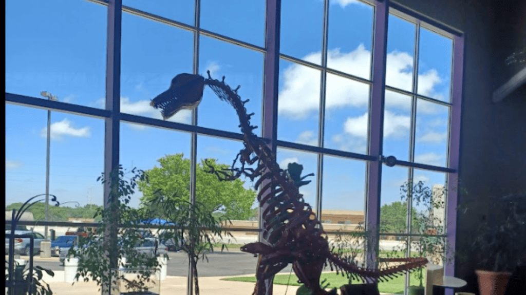dinosaur looking through window at science spectrum lubbock